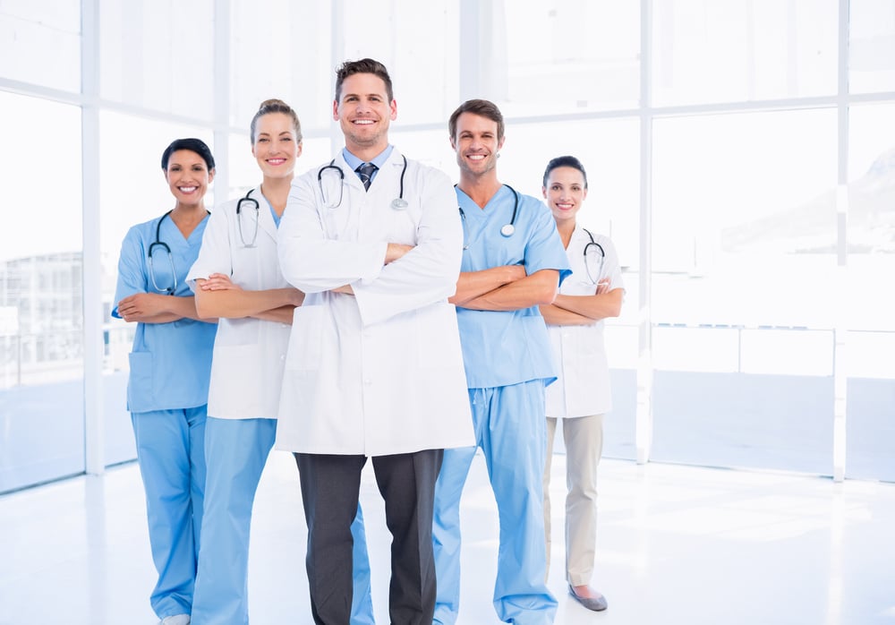 Portrait of confident happy group of doctors standing at the medical office